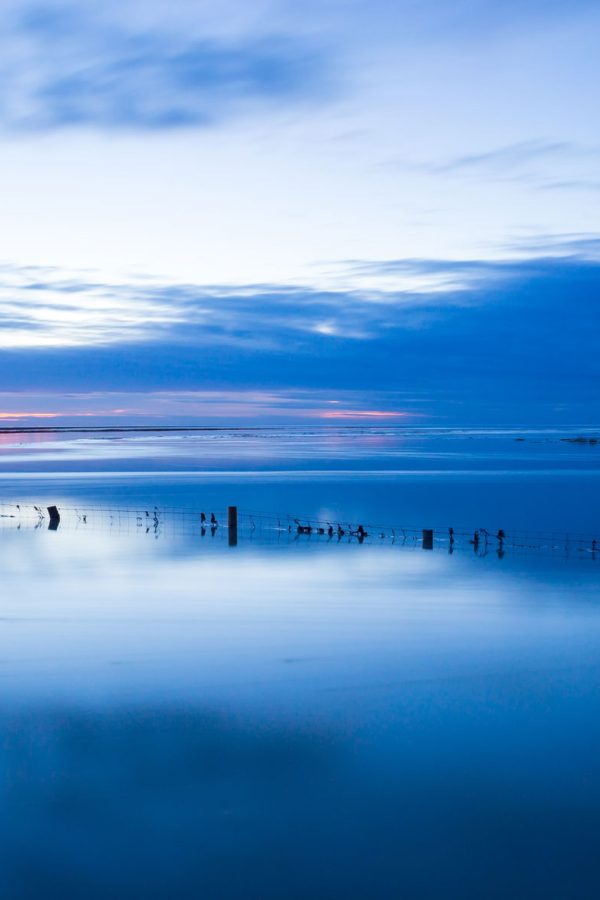 montsaintmichel-sunset-with-deep-blue-water-and-clear-reflections-normandy-france